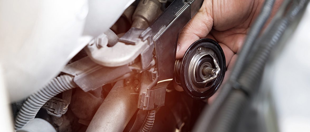 Hand a technician take of Car thermostat in engine room